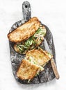 Sandwiches with turmeric grilled chicken, cucumber, microgreens and homemade mustard mayonnaise sauce on a wooden cutting board on Royalty Free Stock Photo