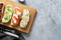 Sandwiches with vegetables, radishes, tomatoes, cucumbers and microgreens on gray. View from above Royalty Free Stock Photo