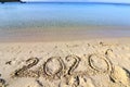 2020 on a sandy background on the beach. New Years concept. Royalty Free Stock Photo