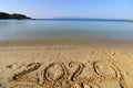 2020 on a sandy background on the beach. New Years concept. Royalty Free Stock Photo