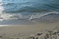 Sandy beach and blue foamy waves