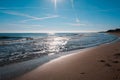 sandy beach of the Bolearic sea with beautiful waves against the background of a sunny sky Royalty Free Stock Photo