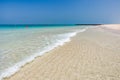 Sandy beach on coast with crystal clear water in sea, red buoys Royalty Free Stock Photo