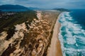 Sandy beach with dunes and blue ocean with sunset lights in Rio Tavares, Florianopolis
