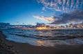 Sandy beach at dusk under a stormy sky. Seascape with waves and dramatic sky with clouds at sunset Royalty Free Stock Photo