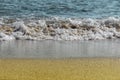Sandy beach and foamed sea water Royalty Free Stock Photo