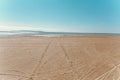 Sandy beach, footprints on the wet sand Royalty Free Stock Photo