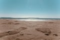 Sandy beach, footprints on the wet sand Royalty Free Stock Photo