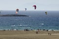 Sandy beach and the kitesurfers on the waves of the Aegean sea Royalty Free Stock Photo