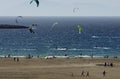 Sandy beach and the kitesurfers on the waves of the Aegean sea Royalty Free Stock Photo