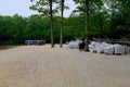 Sandy Beach on Lake With Boats and Stacked Chairs