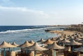 Sandy beach with many straw umbrellas - Red Sea Egypt Africa Royalty Free Stock Photo