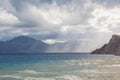 sandy beach with mountain and cloudy sky Royalty Free Stock Photo