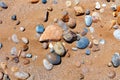 Sandy beach with the multicolor pebbles on the african Atlantic ocean coast Royalty Free Stock Photo