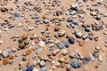 Sandy beach with the multicolor pebbles on the african Atlantic ocean coast Royalty Free Stock Photo