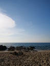 Sandy beach over sea and blue summer sky background Royalty Free Stock Photo