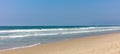 Sandy beach panoramic view. Blue clear sky, blue sea