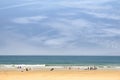 Sandy beach with people going to surf Royalty Free Stock Photo