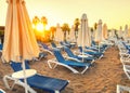 beach without people and with sun loungers, folded umbrellas, palm trees, Turkey, Side resort