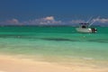 Sandy beach, powerboat, ocean. Trou aux Biches, Mauritius Royalty Free Stock Photo