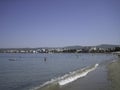 Sandy beach in quiet Sunny weather. Weak surf caressing the coastal sand