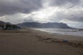 Sandy beach with rough sea and clouds Royalty Free Stock Photo