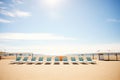 sandy beach with rows of empty sunbeds