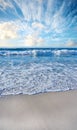 Sandy beach, sea, blue sky with clouds and copy space. Scenic seascape view of ocean waves washing on shore sand in a Royalty Free Stock Photo