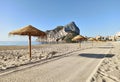 Sandy beach with straw parasols in Calpe. Spain