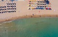 sandy beach with sun beds umbrellas in neat rows on the tsambika beach Rhodes Greece. The concept of a holiday resort view from Royalty Free Stock Photo