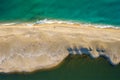 Sandy beach surrounded by sea and river