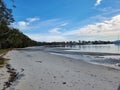 Sandy Beach at Tanilba Bay with coastal forest growing down to the water\'s edge Royalty Free Stock Photo