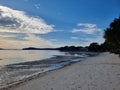 Sandy Beach at Tanilba Bay with coastal forest growing down to the water\'s edge Royalty Free Stock Photo