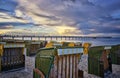 Sandy beach and traditional wooden beach chairs on the lake bridge, Northern Germany, on the coast of Baltic Sea Royalty Free Stock Photo