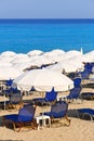 Sandy beach with white parasols and sunbeds Royalty Free Stock Photo