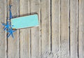 Sandy boardwalk planks background with blue starfish and turquoise metal