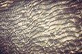 Sandy bottom with reflecting sunlight from water ripples Royalty Free Stock Photo