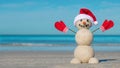 Sandy Christmas snowman on the beach. Snowman from sand. Merry Christmas celebration party. Royalty Free Stock Photo