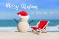 Sandy Christmas Snowman is celebrating Christmas Holidays on a beautiful beach Royalty Free Stock Photo