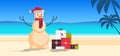 Sandy christmas snowman with gift present boxes happy new year vacation holiday celebration concept tropical beach Royalty Free Stock Photo