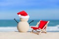 Sandy Christmas Snowman is celebrating Christmas Holidays on a beautiful beach