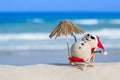 Sandy Christmas Snowman is sunbathing on a beach Royalty Free Stock Photo