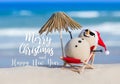 Sandy Christmas Snowman is sunbathing on a beach Royalty Free Stock Photo