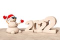 Sandy Christmas Snowman at Sunny Beach with 2022 New Year Sign. 3d Rendering