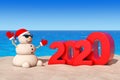 Sandy Christmas Snowman at Sunny Beach with 2020 New Year Sign. 3d Rendering