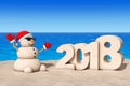 Sandy Christmas Snowman at Sunny Beach with 2018 New Year Sign.