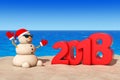 Sandy Christmas Snowman at Sunny Beach with 2018 New Year Sign.