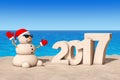 Sandy Christmas Snowman at Sunny Beach with 2017 Ney Year Sign.