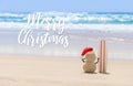 Sandy Christmas Snowman is watching the waves Royalty Free Stock Photo