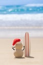 Sandy Christmas Snowman is watching the waves Royalty Free Stock Photo